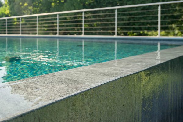 infinity edge swimming pool with stainless steel barrier